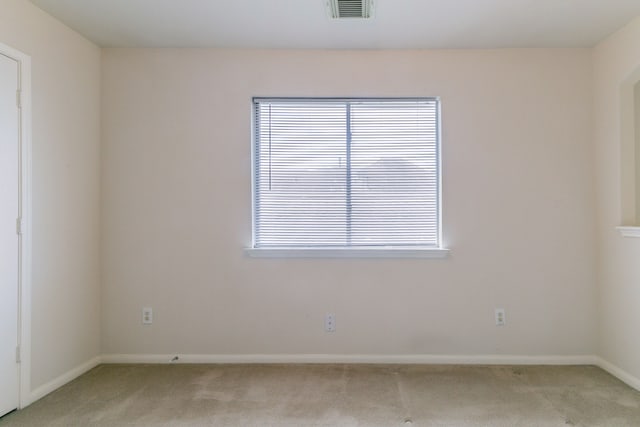 unfurnished room with light carpet, baseboards, and visible vents