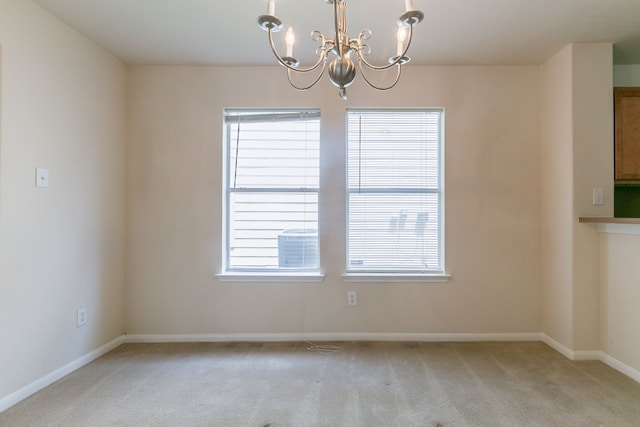 unfurnished dining area with light carpet, a notable chandelier, and a healthy amount of sunlight