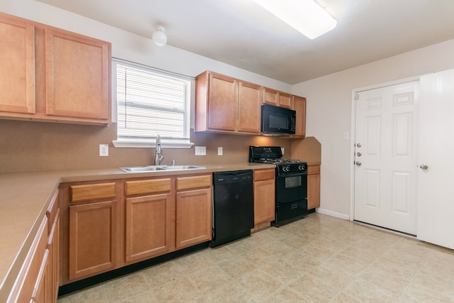 kitchen featuring light countertops, a sink, and black appliances