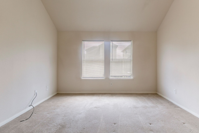 unfurnished room featuring carpet floors and baseboards