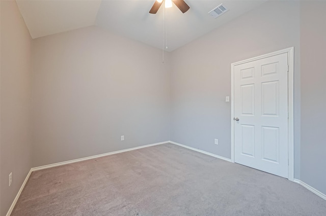 spare room featuring lofted ceiling, visible vents, a ceiling fan, carpet floors, and baseboards