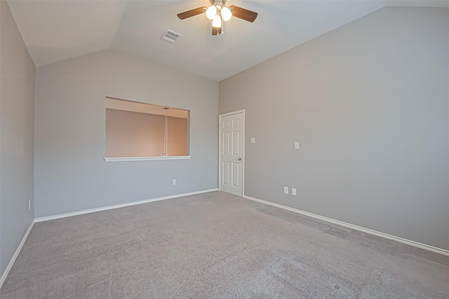 unfurnished room featuring lofted ceiling, baseboards, visible vents, and ceiling fan