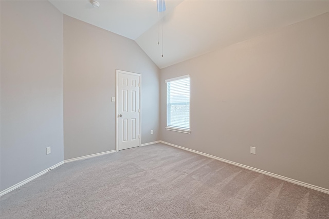 empty room with vaulted ceiling, baseboards, carpet floors, and ceiling fan