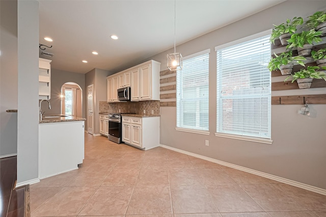 kitchen with open shelves, a sink, decorative backsplash, stainless steel appliances, and recessed lighting