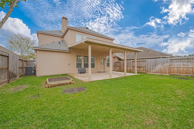 rear view of property with a lawn, central AC unit, and a patio