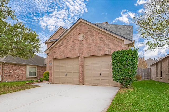 view of front of property featuring driveway, fence, brick siding, an attached garage, and a front yard