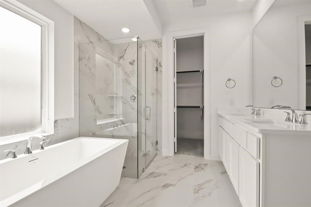 122 Canary Island Cir, Montgomery, TX 77316 - full bath with marble finish floors, a marble finish shower, a walk in closet, a freestanding tub, and double vanity