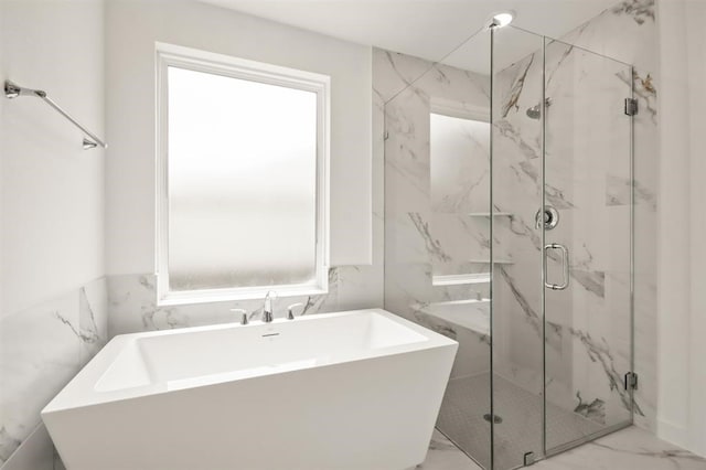 122 Canary Island Cir, Montgomery, TX 77316 - bathroom featuring a marble finish shower, marble look tile flooring, a freestanding tub, and tile walls