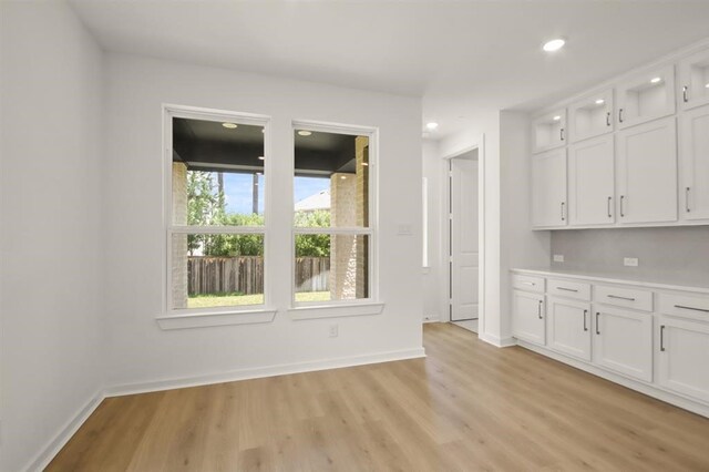 122 Canary Island Cir, Montgomery, TX 77316 - unfurnished dining area with light wood-type flooring, baseboards, and recessed lighting