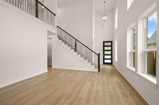 122 Canary Island Cir, Montgomery, TX 77316 - foyer featuring a high ceiling, wood finished floors, stairs, and a chandelier