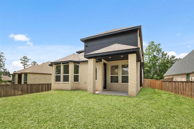122 Canary Island Cir, Montgomery, TX 77316 - back of property with a patio area, a fenced backyard, roof with shingles, and brick siding