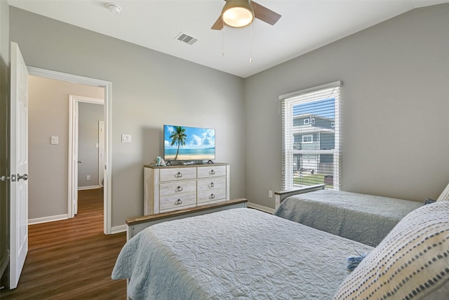 16605 Flounder Way, Jamaica Beach, TX 77554 - bedroom with baseboards, visible vents, ceiling fan, and dark wood finished floors