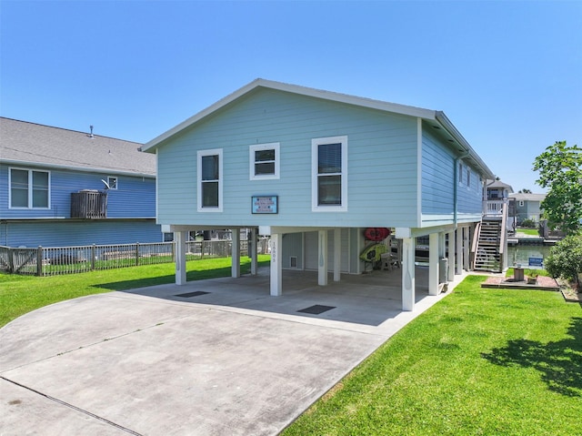 16605 Flounder Way, Jamaica Beach, TX 77554 - back of house with a carport, driveway, and stairs