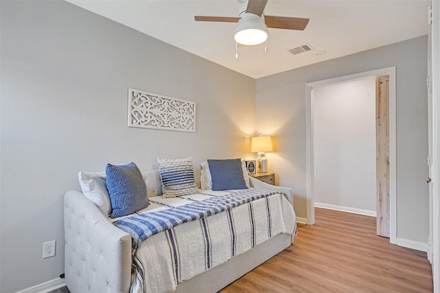 16605 Flounder Way, Jamaica Beach, TX 77554 - bedroom with ceiling fan, baseboards, wood finished floors, and visible vents