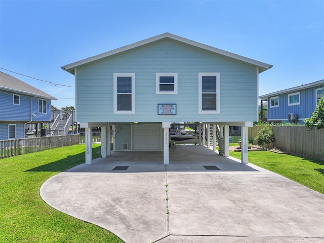 16605 Flounder Way, Jamaica Beach, TX 77554 - back of house with stairs, a carport, a garage, and driveway