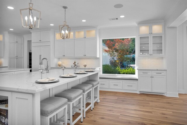 16059 Walden Rd, Conroe, TX 77356 - kitchen with white cabinetry, an inviting chandelier, and recessed lighting