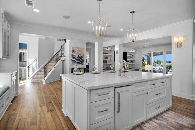16059 Walden Rd, Conroe, TX 77356 - kitchen featuring white cabinets, crown molding, visible vents, and a sink