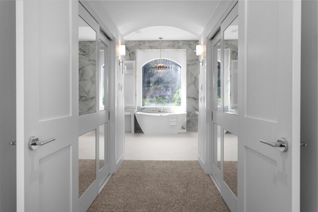 16059 Walden Rd, Conroe, TX 77356 - hallway with a notable chandelier, french doors, and carpet floors