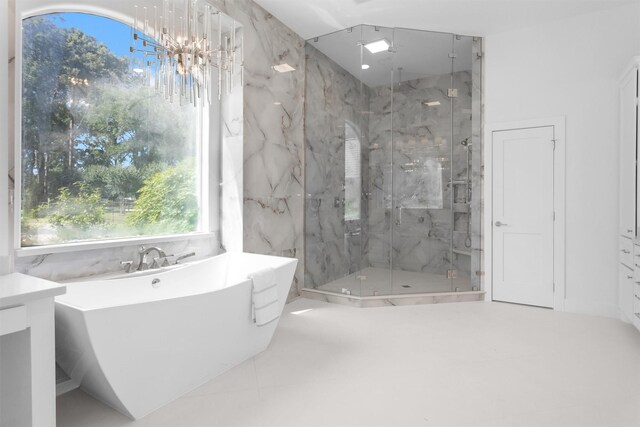 16059 Walden Rd, Conroe, TX 77356 - bathroom with a freestanding bath, a wealth of natural light, a marble finish shower, and a notable chandelier