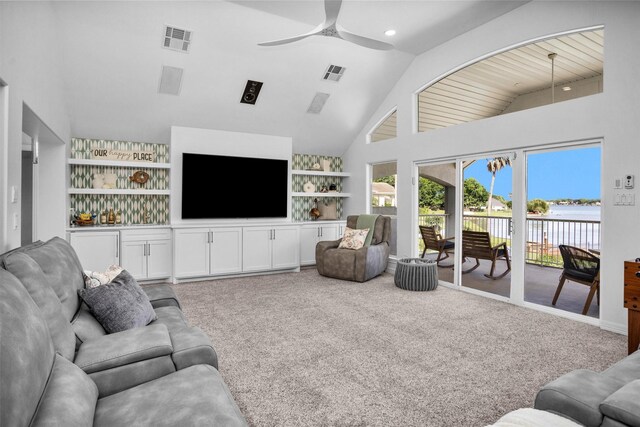 16059 Walden Rd, Conroe, TX 77356 - living room with carpet, visible vents, built in shelves, and ceiling fan