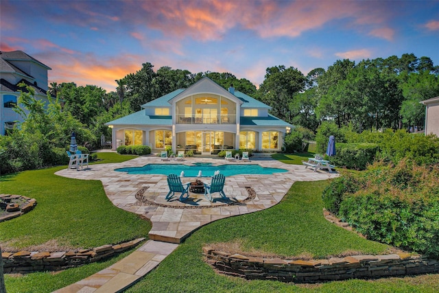 16059 Walden Rd, Conroe, TX 77356 - rear view of house with a balcony, a patio area, an outdoor pool, and a yard