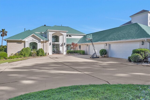 16059 Walden Rd, Conroe, TX 77356 - traditional-style house with brick siding, driveway, and a garage