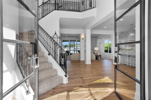 16059 Walden Rd, Conroe, TX 77356 - entrance foyer featuring wood finished floors, a towering ceiling, ornamental molding, and stairs