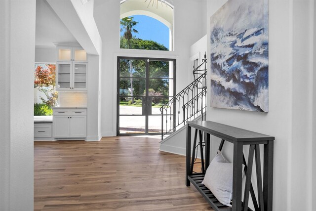 16059 Walden Rd, Conroe, TX 77356 - entryway featuring stairway, wood finished floors, baseboards, and a high ceiling