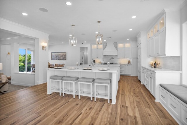 16059 Walden Rd, Conroe, TX 77356 - kitchen featuring custom exhaust hood, recessed lighting, decorative backsplash, and white cabinets