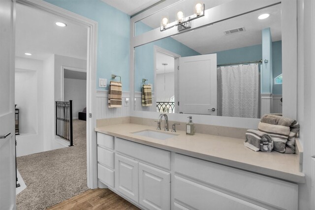 16059 Walden Rd, Conroe, TX 77356 - bathroom featuring wood finished floors, vanity, visible vents, recessed lighting, and an inviting chandelier