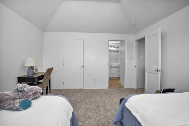16059 Walden Rd, Conroe, TX 77356 - bedroom with ensuite bath, lofted ceiling, carpet, and baseboards