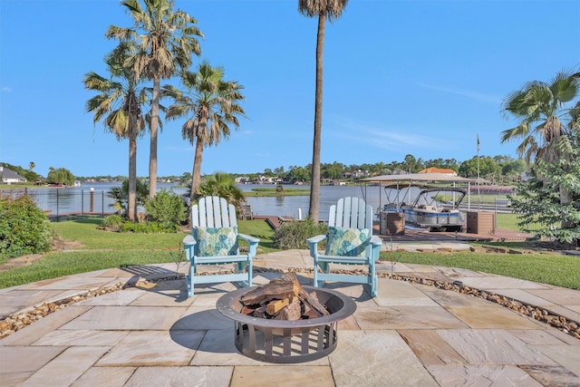 16059 Walden Rd, Conroe, TX 77356 - view of patio featuring an outdoor fire pit, a water view, and fence