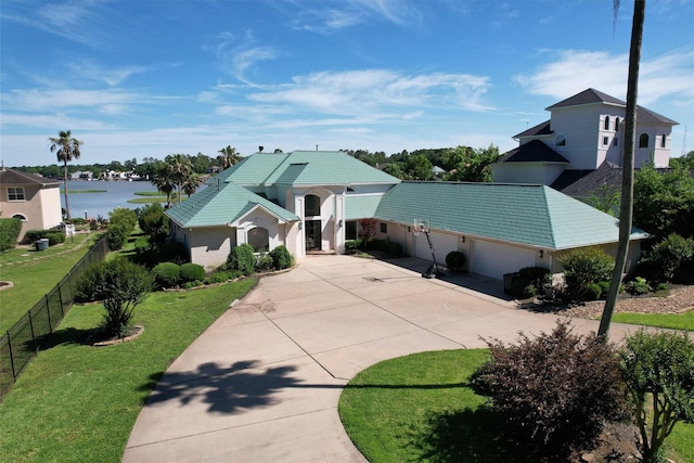 16059 Walden Rd, Conroe, TX 77356 - ranch-style home featuring fence, an attached garage, driveway, a front lawn, and a water view