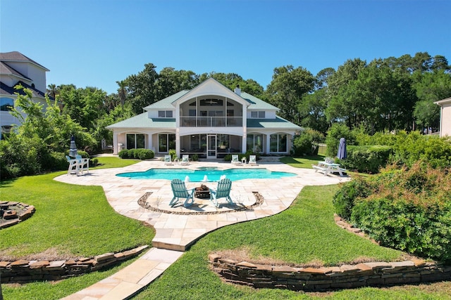 16059 Walden Rd, Conroe, TX 77356 - back of property with a yard, a patio area, an outdoor pool, and a balcony