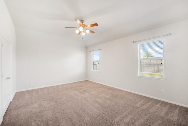 empty room featuring carpet floors, a ceiling fan, and baseboards