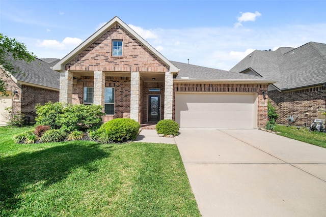 view of front of home featuring brick siding, a front yard, driveway, and a garage
