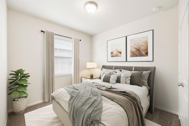 bedroom featuring baseboards and carpet