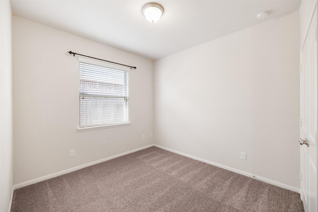 carpeted empty room with baseboards