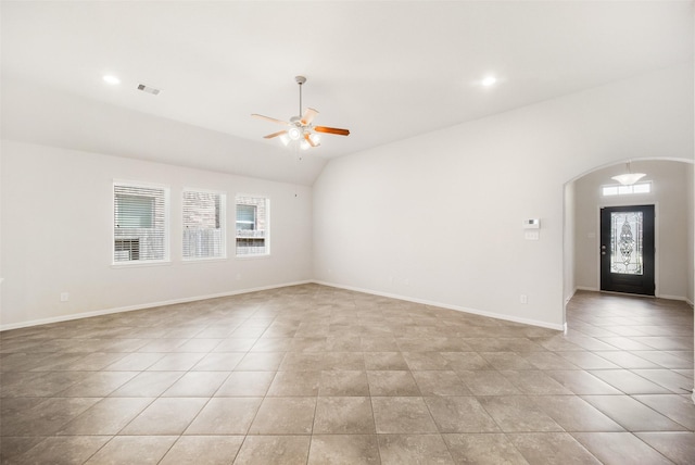 interior space featuring ceiling fan, arched walkways, a healthy amount of sunlight, and visible vents
