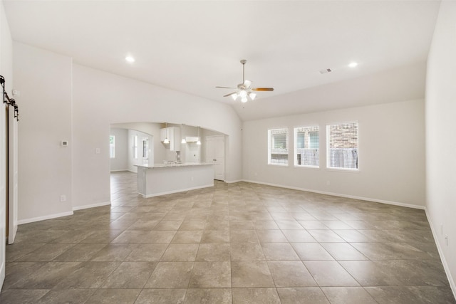 unfurnished living room featuring ceiling fan, arched walkways, lofted ceiling, and baseboards