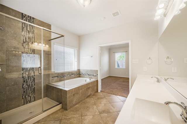 bathroom featuring a bath, tile patterned floors, a sink, visible vents, and a shower stall
