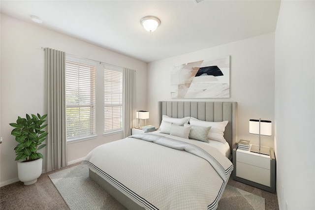 bedroom with baseboards and carpet floors