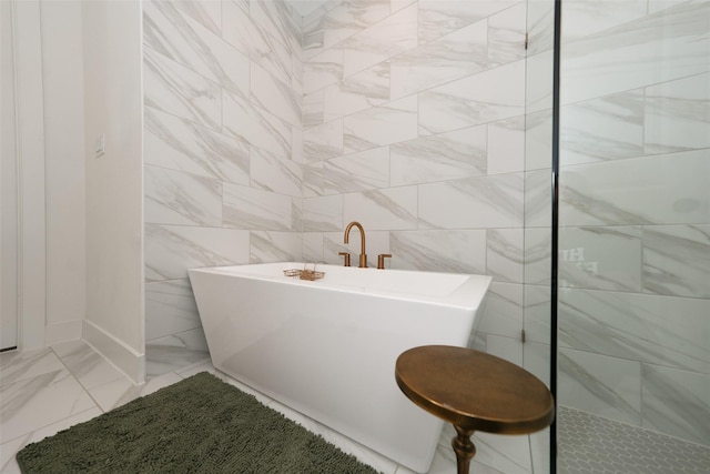 14924 Scarlet Branch Dr, Conroe, TX 77302 - full bathroom featuring a freestanding tub, marble finish floor, and a tile shower
