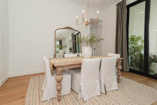 14924 Scarlet Branch Dr, Conroe, TX 77302 - dining space featuring baseboards, light wood-style floors, and a chandelier