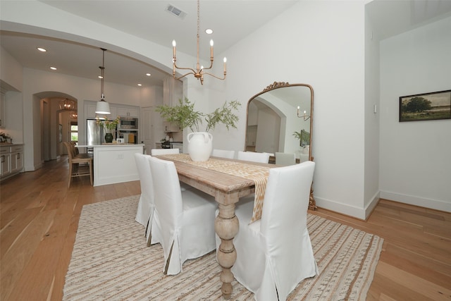 14924 Scarlet Branch Dr, Conroe, TX 77302 - dining space with light wood finished floors, arched walkways, visible vents, recessed lighting, and a chandelier