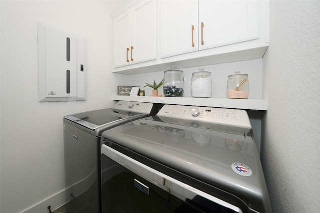 14924 Scarlet Branch Dr, Conroe, TX 77302 - laundry area with electric panel, washer and clothes dryer, and cabinet space