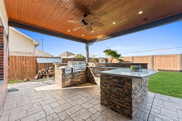 14911 Hurst Point Ln, Houston, TX 77049 - view of patio with exterior kitchen, a fenced backyard, grilling area, a ceiling fan, and a bar
