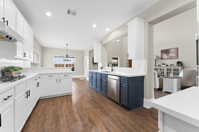 14911 Hurst Point Ln, Houston, TX 77049 - kitchen featuring appliances with stainless steel finishes, blue cabinets, a sink, white cabinetry, and tasteful backsplash