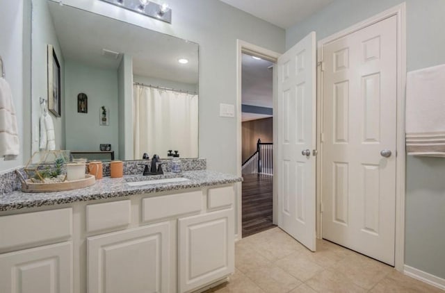 14911 Hurst Point Ln, Houston, TX 77049 - bathroom with vanity, tile patterned floors, and baseboards