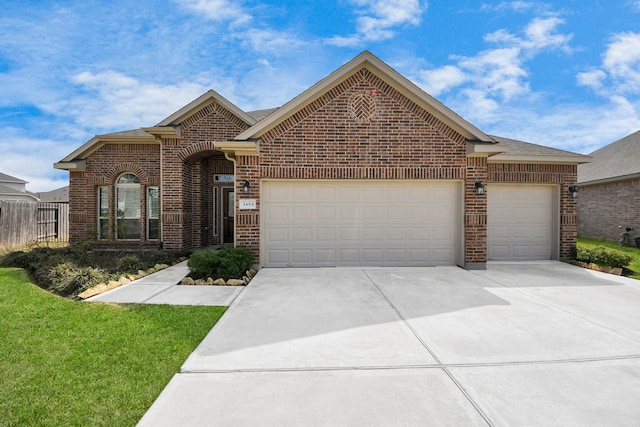 view of front of property featuring brick siding, an attached garage, concrete driveway, and fence